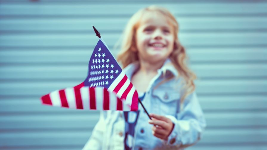 Little girl holding American flag.